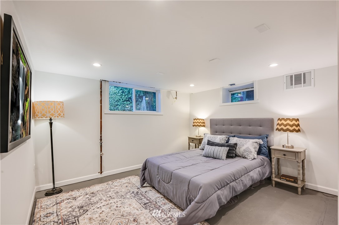6016 44th Avenue Southwest Seattle, WA 98136 - Photo 28 of 35 a bedroom with a bed and a cabinets