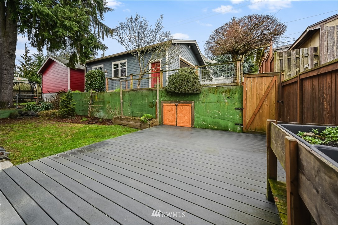 6016 44th Avenue Southwest Seattle, WA 98136 - Photo 34 of 35 a front view of a house with a yard and garage