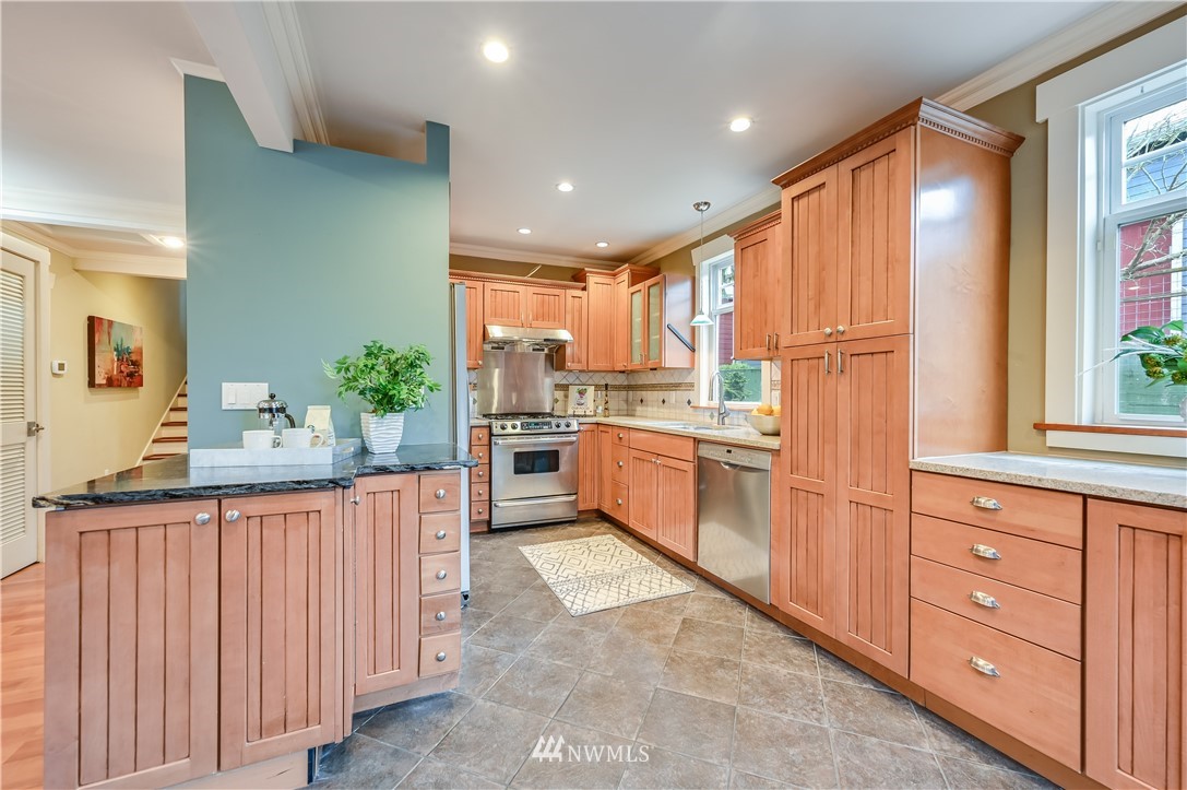 6016 44th Avenue Southwest Seattle, WA 98136 - Photo 9 of 35 a kitchen with granite countertop white cabinets and white appliances