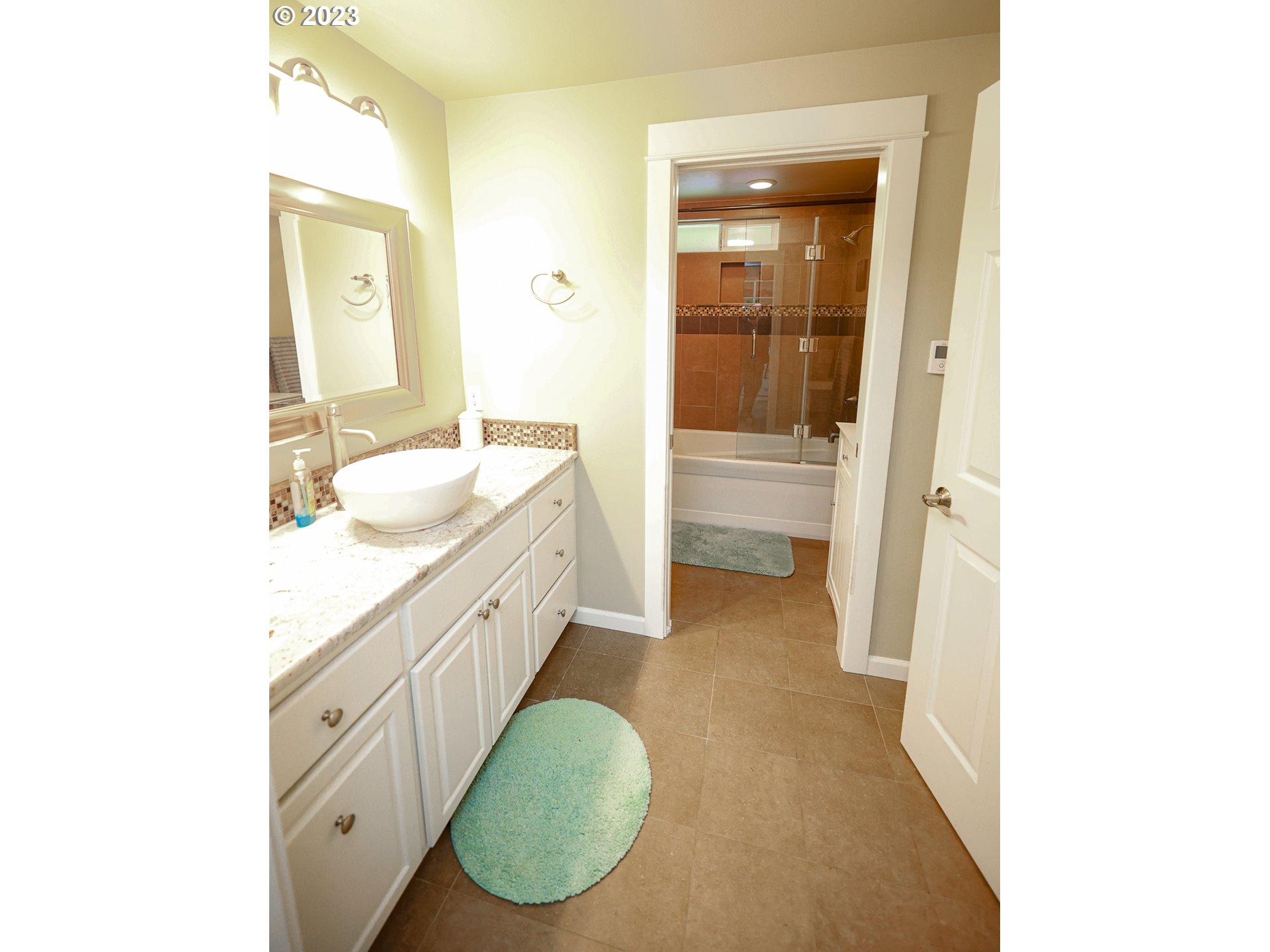 2465 South Bertelsen Road Eugene, OR 97405 - Photo 12 of 26 a spacious bathroom with a granite countertop sink and a mirror