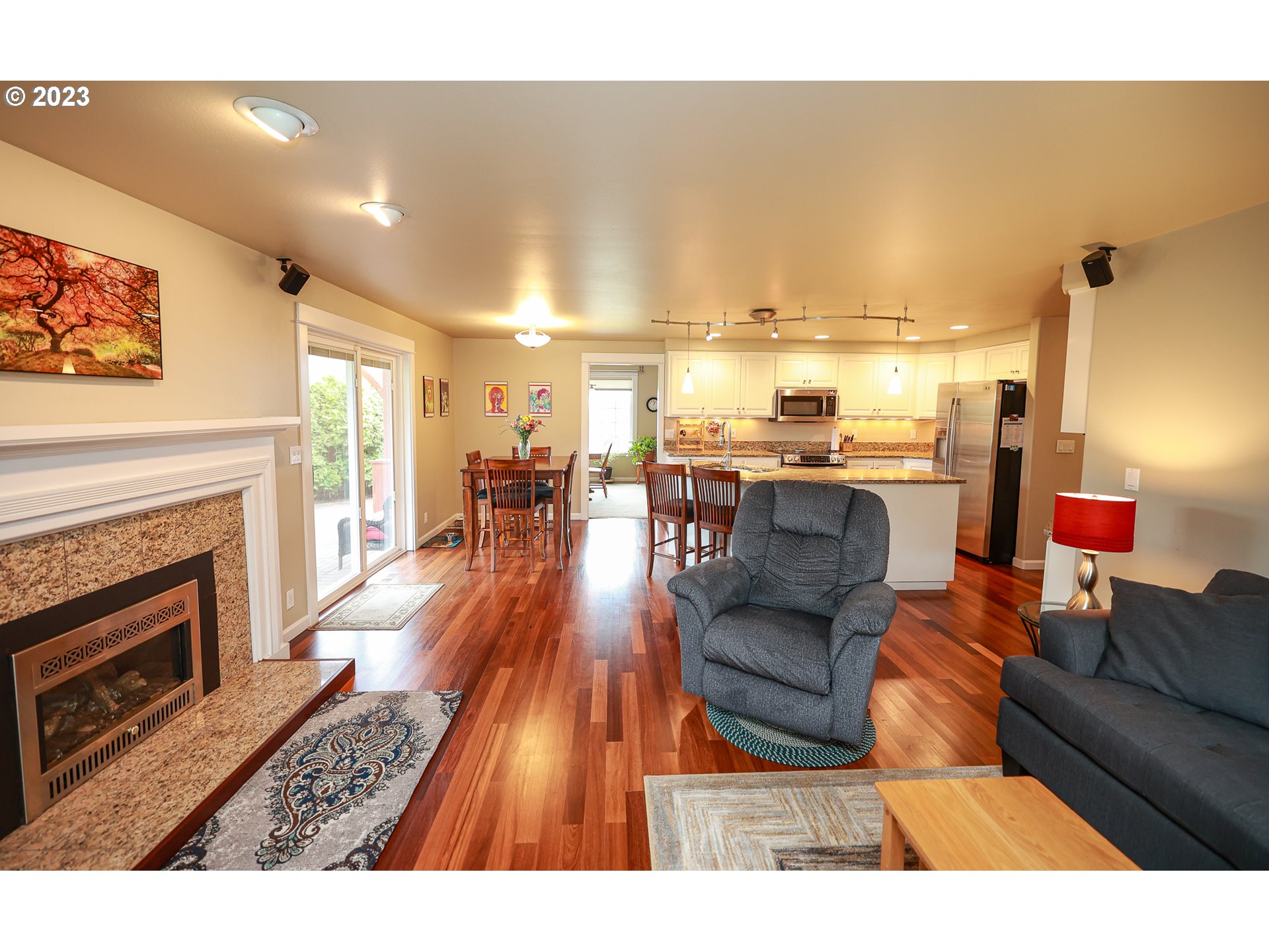 2465 South Bertelsen Road Eugene, OR 97405 - Photo 5 of 26 a living room with stainless steel appliances furniture a fireplace and a flat screen tv