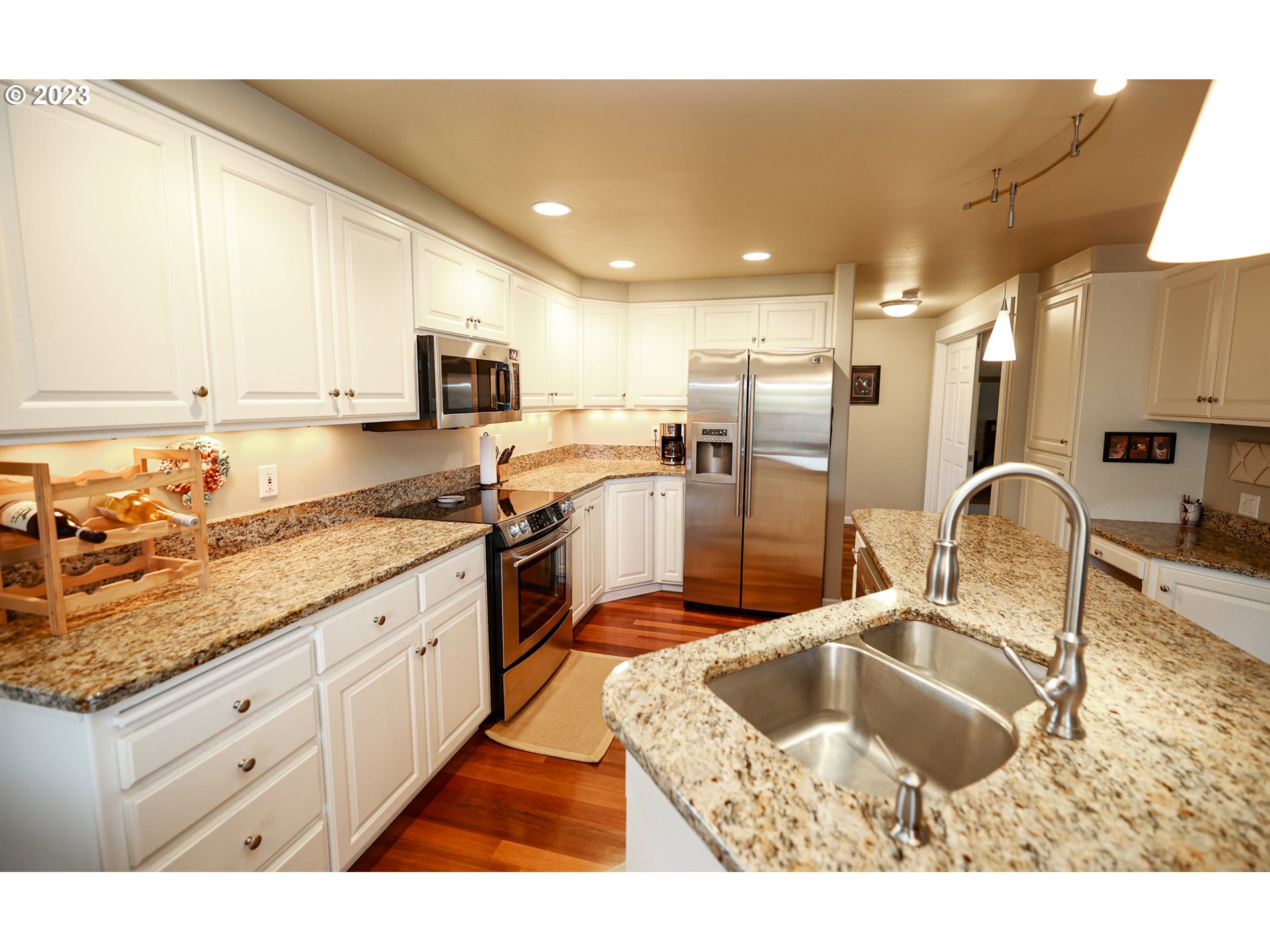 2465 South Bertelsen Road Eugene, OR 97405 - Photo 6 of 26 a kitchen with stainless steel appliances granite countertop a sink stove and refrigerator