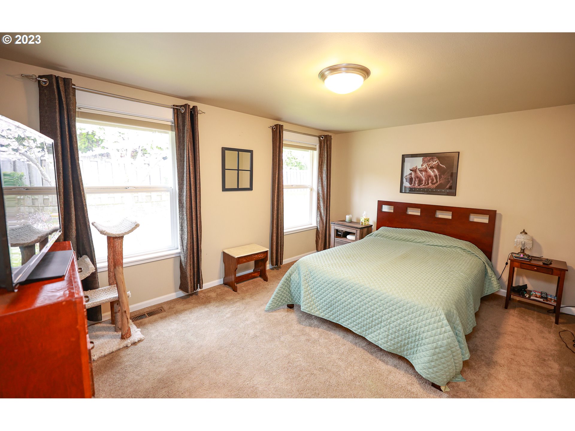 2465 South Bertelsen Road Eugene, OR 97405 - Photo 10 of 26 a bedroom with a bed a table and a large window