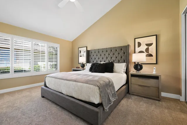 a bedroom with a bed and a painting on the wall