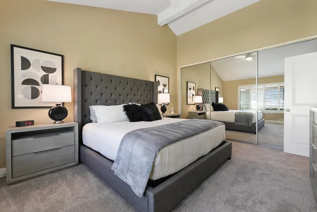 a large bedroom with a bed and window