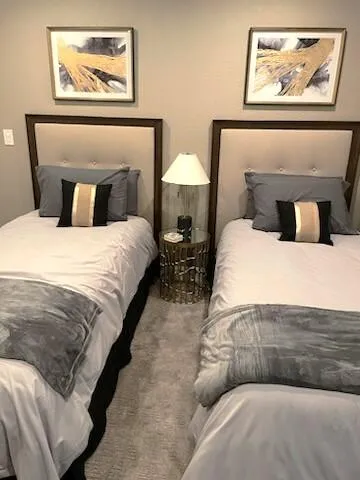 a bedroom with bed and wall painting