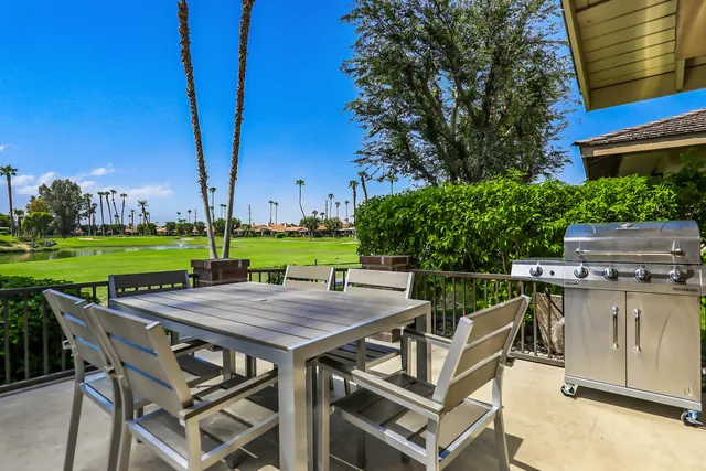 a view of a patio with table and chairs and potted plants
