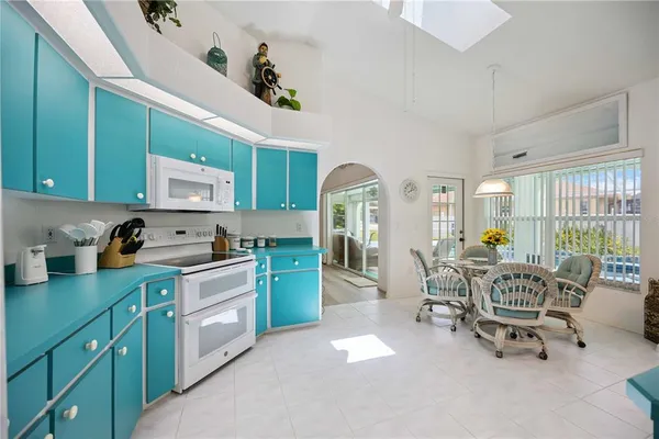 a kitchen with cabinets table and chairs