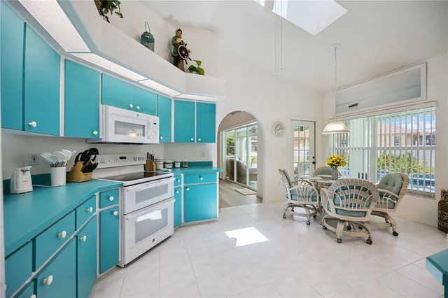 a kitchen with cabinets table and chairs