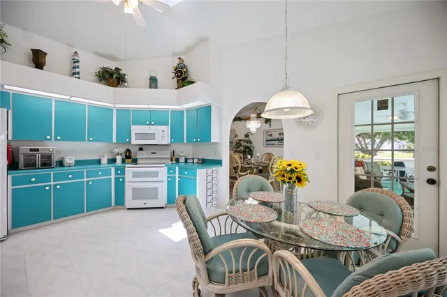 a outdoor dining room with furniture a kitchen island furniture and a chandelier