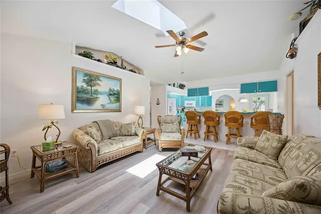 a living room with furniture ceiling fan and a rug
