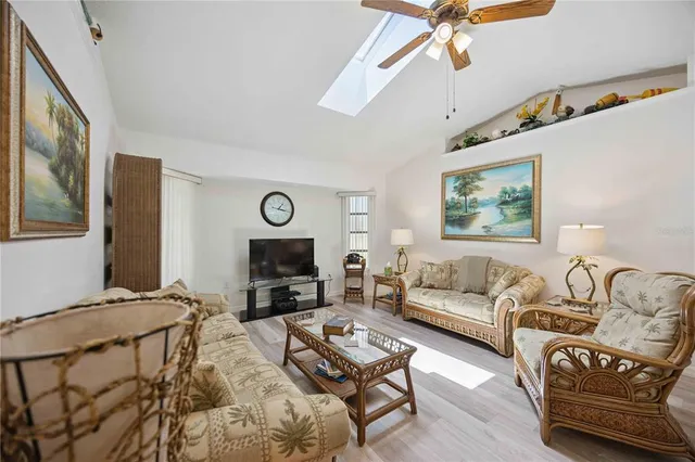 a living room with furniture a couch and a flat screen tv