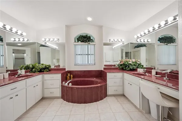a large spacious bathroom with a granite countertop tub sink and mirror