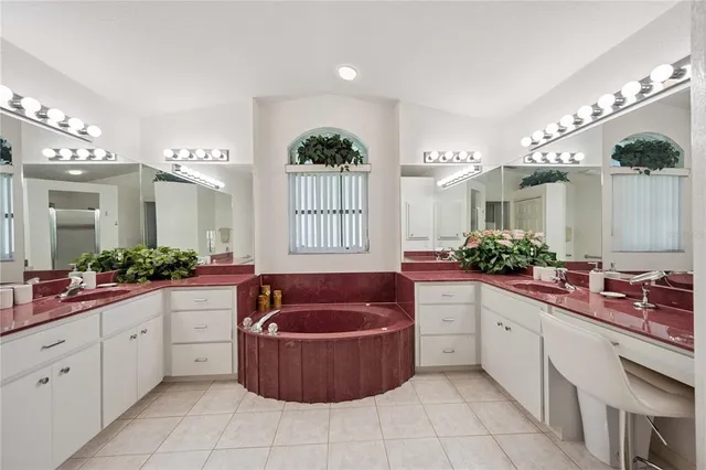 a large spacious bathroom with a granite countertop tub sink and mirror