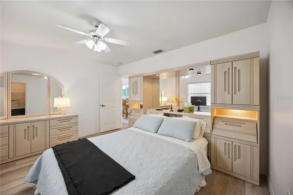 a bedroom with a bed and a chandelier