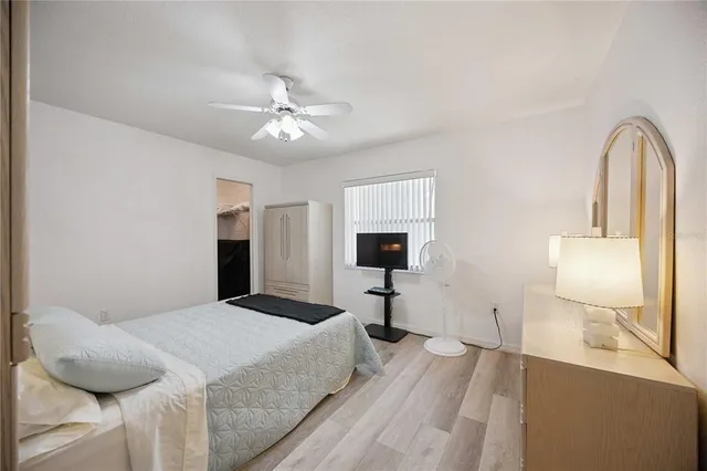 a bedroom with a bed and a mirror