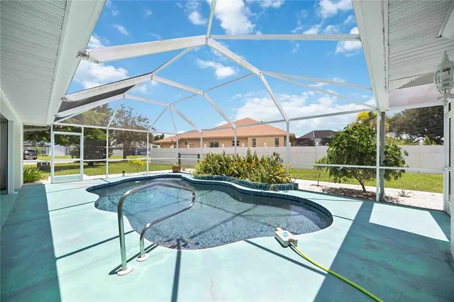 a swimming pool with large glass windows and painted walls