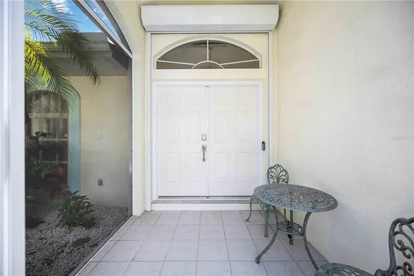 a view of entryway with table and chair