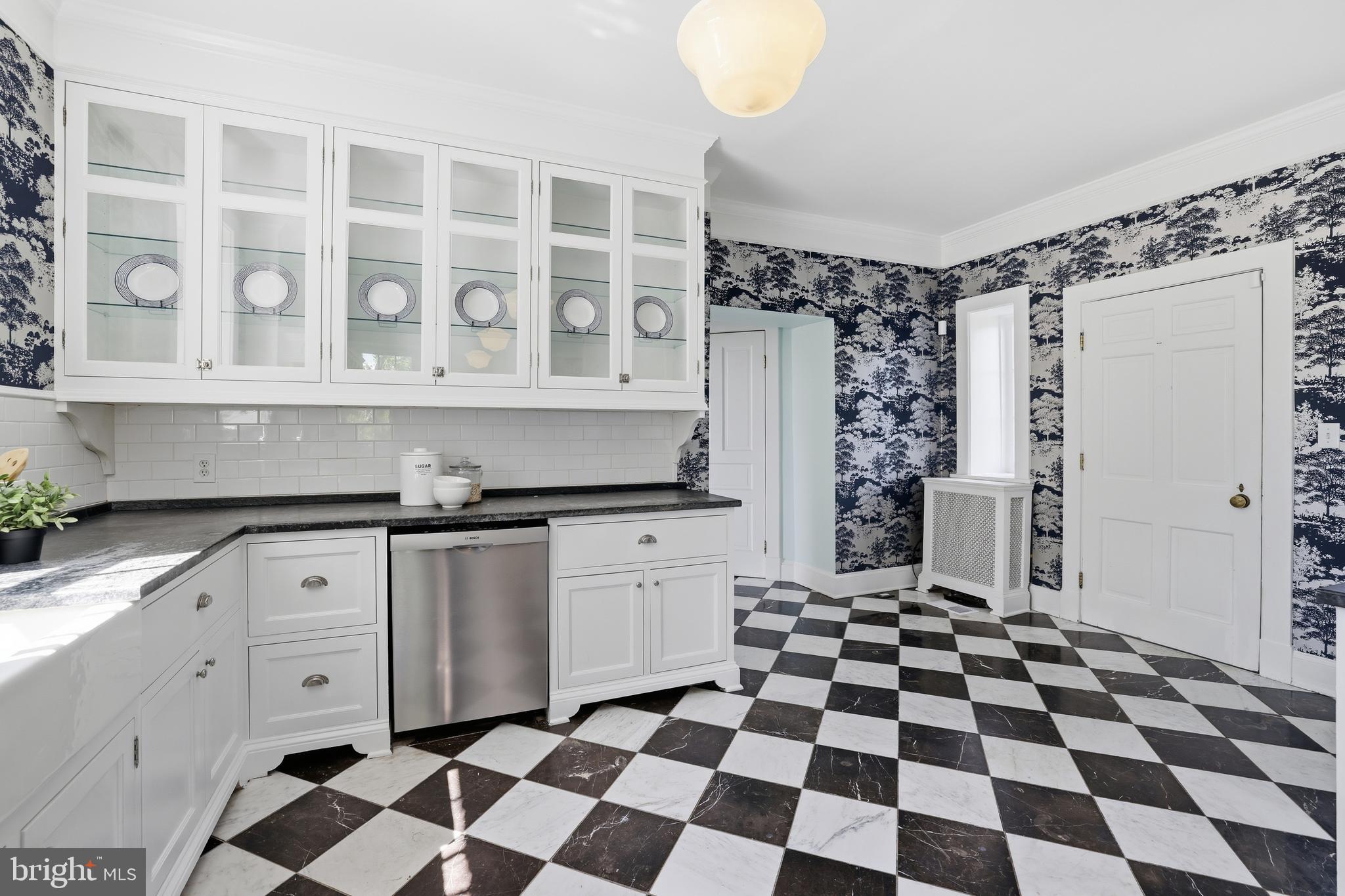 17781 Roxbury Hall Road Leesburg, VA 20175 - Photo 24 of 107 a kitchen with a checkered floor and white cabinets