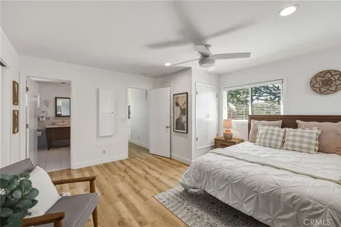 a bedroom with furniture and a flat screen tv