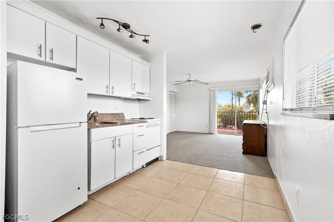 8141 Country Road, Unit 202 Fort Myers, FL 33919 - Photo 14 of 22 a kitchen with cabinets and a refrigerator