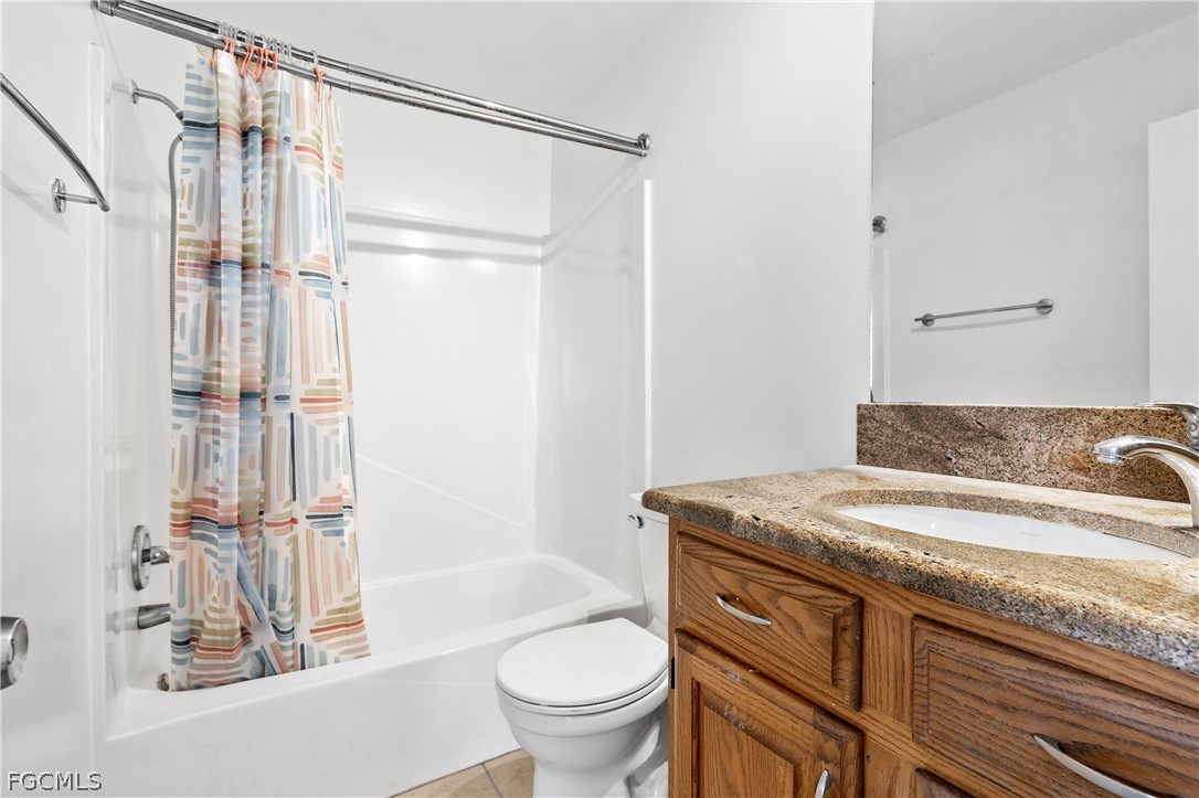 8141 Country Road, Unit 202 Fort Myers, FL 33919 - Photo 18 of 22 a bathroom with a granite countertop sink toilet and shower