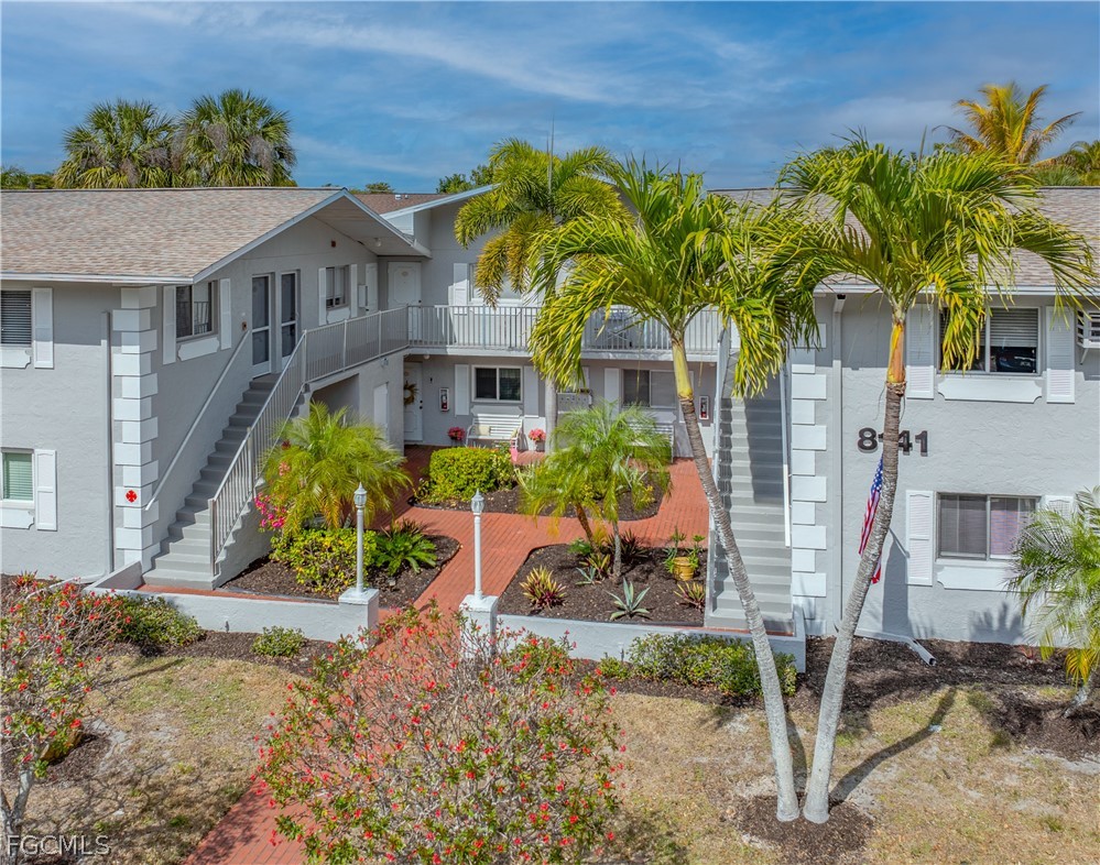 8141 Country Road, Unit 202 Fort Myers, FL 33919 - Photo 2 of 22 a front view of a house with garden