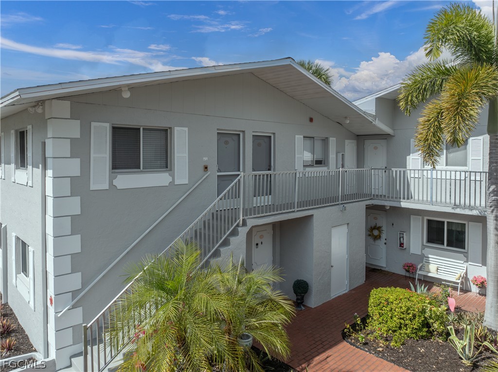 8141 Country Road, Unit 202 Fort Myers, FL 33919 - Photo 6 of 22 a front view of a house with garden