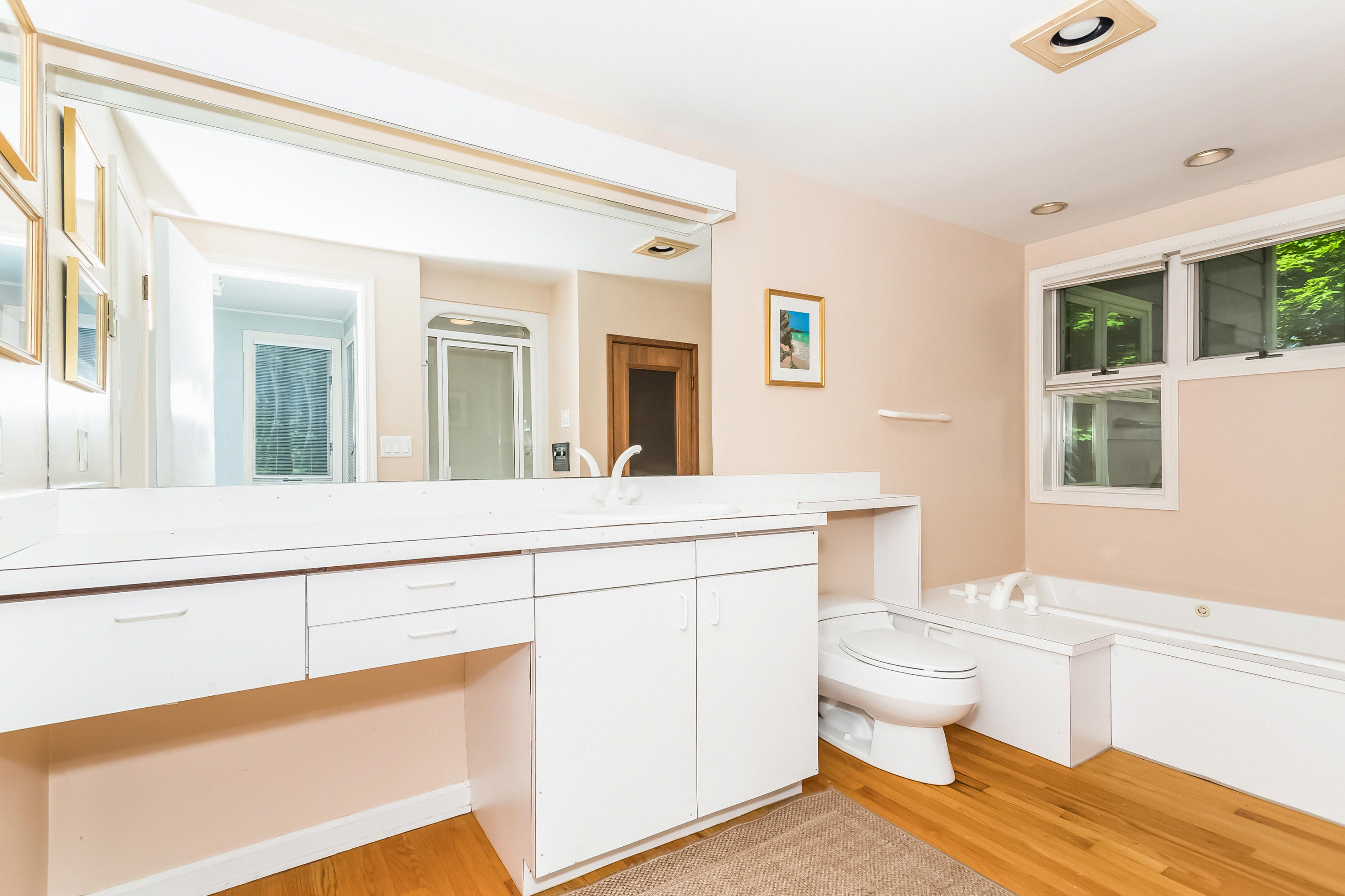 9 Little Brook Road Rowayton, CT 06853 - Photo 22 of 35 a spacious bathroom with a toilet a sink and a mirror