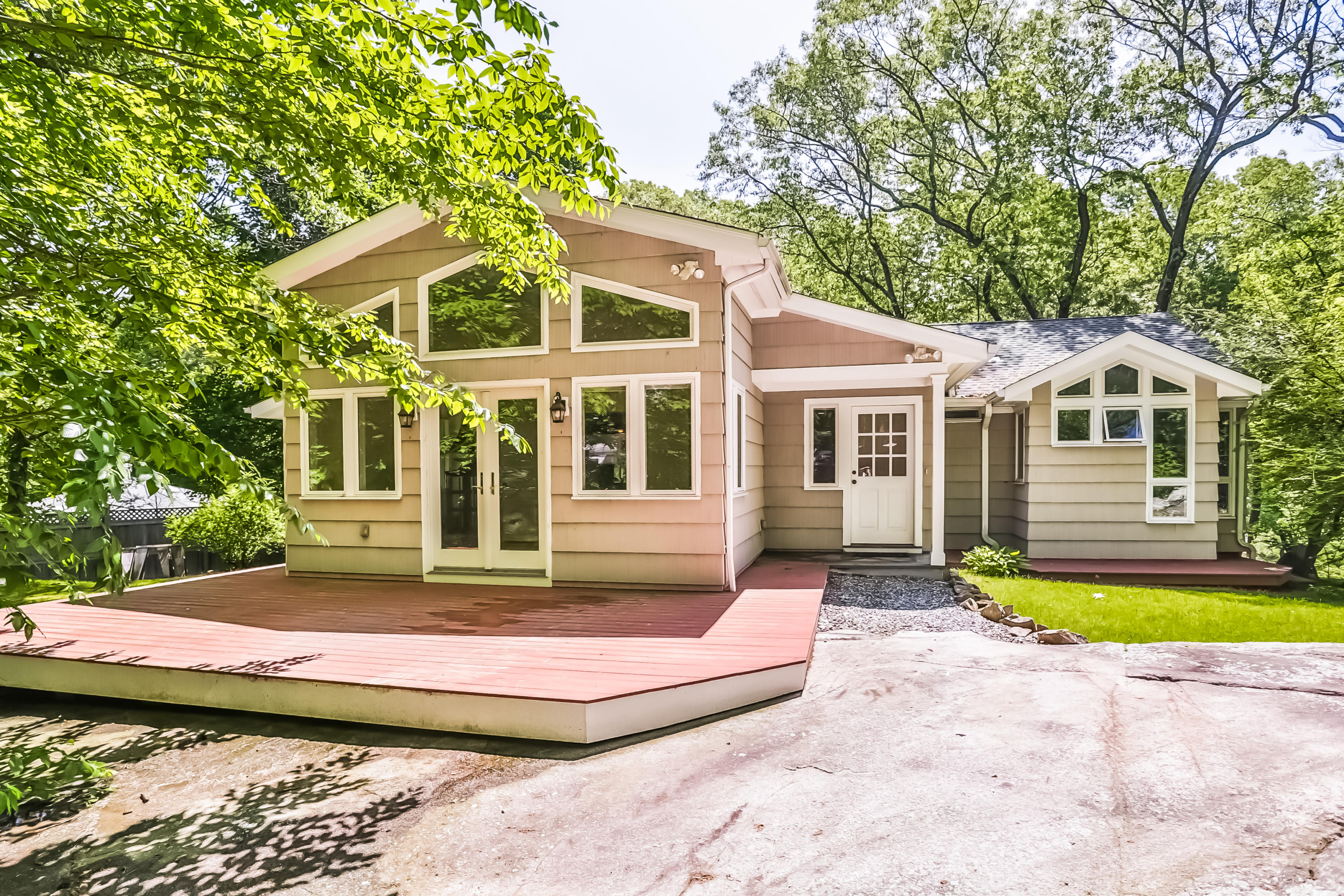 9 Little Brook Road Rowayton, CT 06853 - Photo 28 of 35 a front view of a house with a garden and trees
