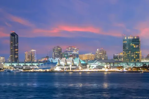 a view of a city with tall buildings and a lake