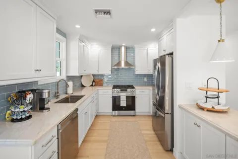 a kitchen with refrigerator a sink and cabinets
