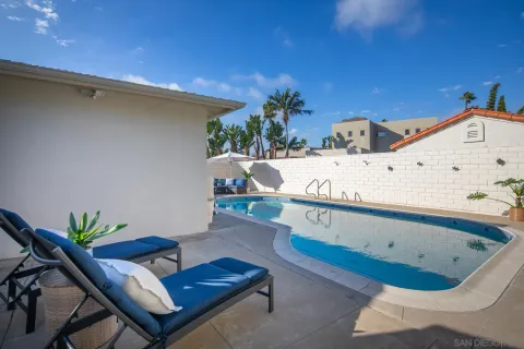 a view of a swimming pool with furniture