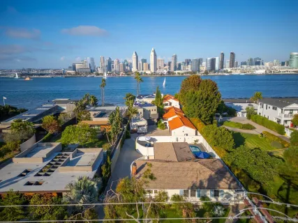 an aerial view of a house with a swimming pool patio and lake view