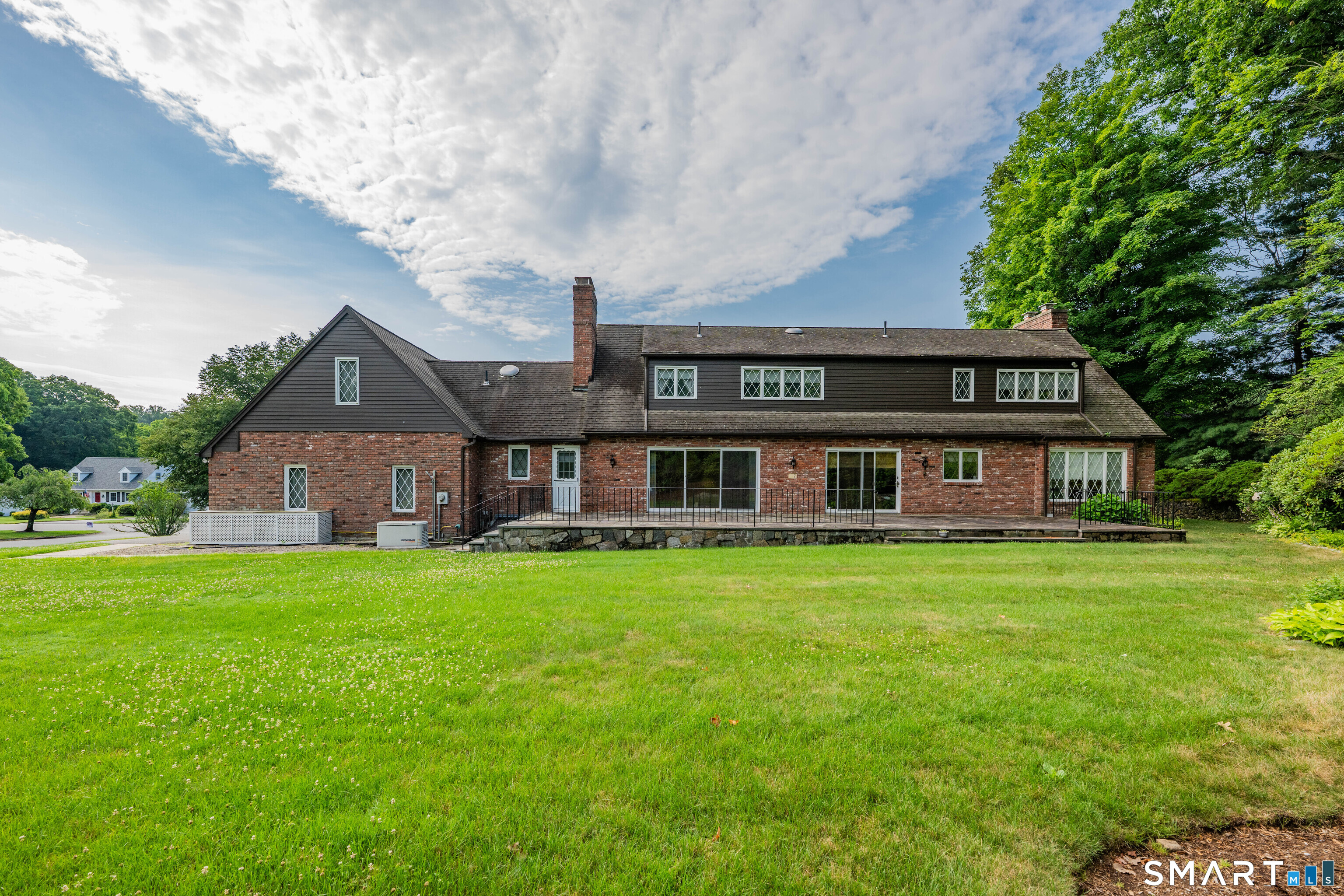 232 Maybrook Road Waterbury, CT 06708 - Photo 2 of 38 a view of a big house with a big yard and large trees