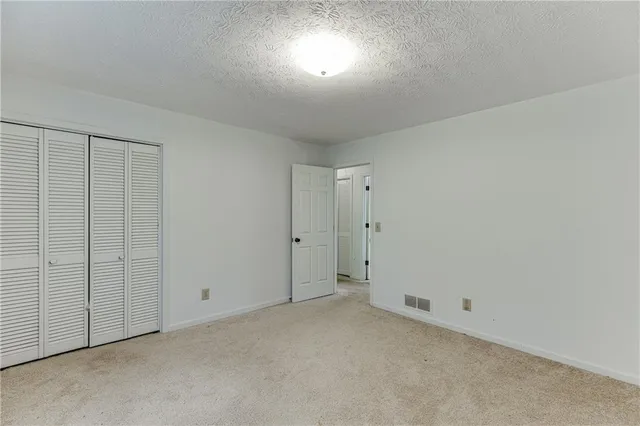 a bedroom with bed and a window