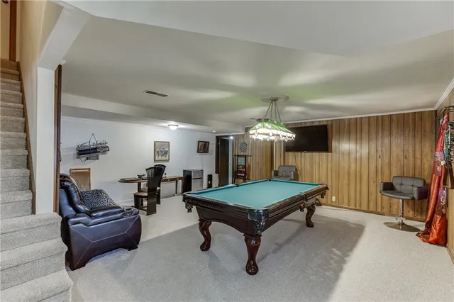 a room with furniture and pool table
