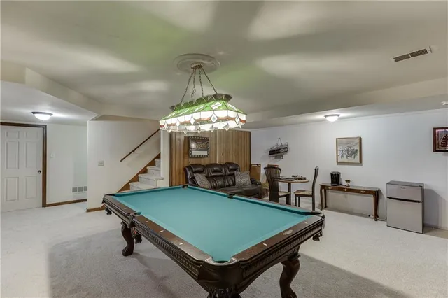 a living room with furniture a air conditioner and a window