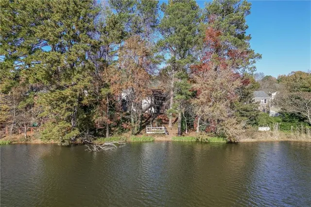 an aerial view of a houses with a lake view