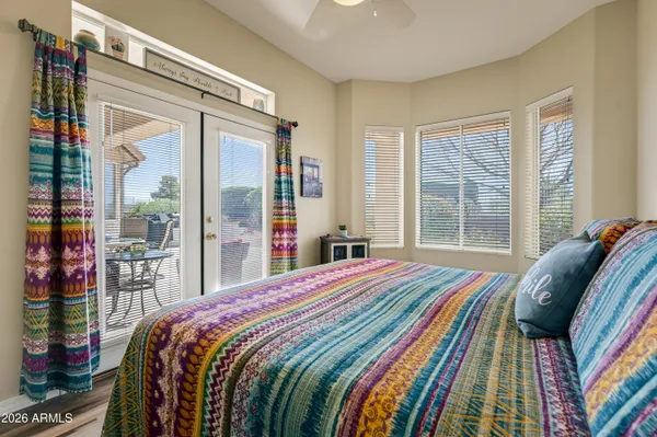 a bedroom with a bed and a large window