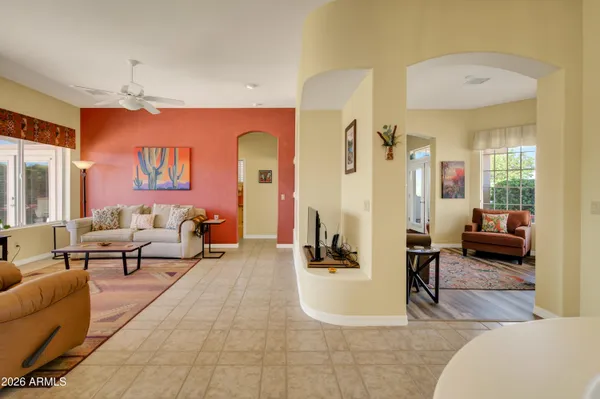a living room with furniture and a chandelier