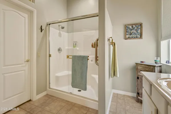 a bathroom with a shower and a sink