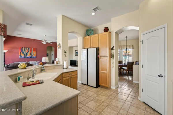 a kitchen with stainless steel appliances granite countertop a refrigerator and a sink