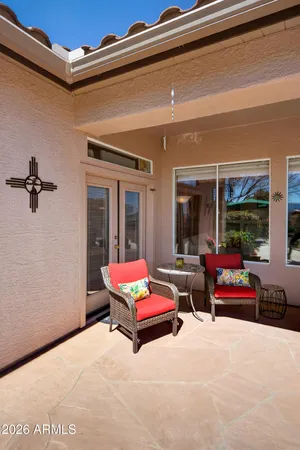 a patio with a table and chairs
