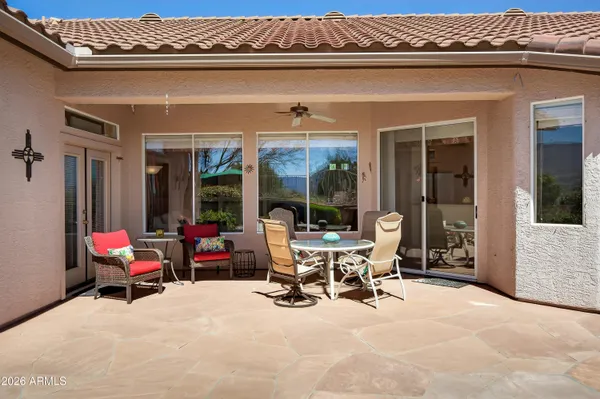 a view of a patio with table and chairs and potted plants