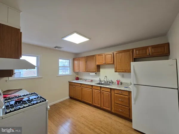 a kitchen with stainless steel appliances granite countertop a refrigerator sink and cabinets