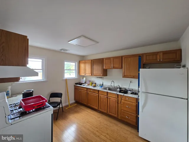 a kitchen with a sink stove and refrigerator