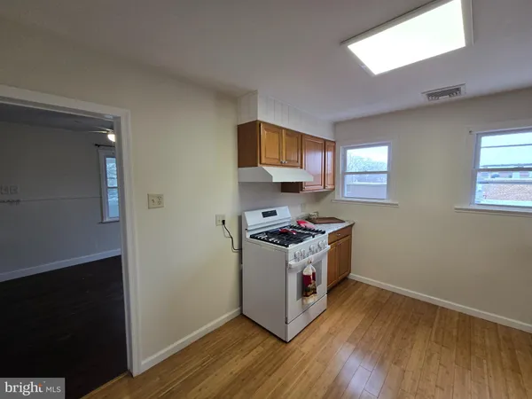 a kitchen with wooden floor and a stove