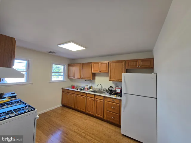 a kitchen with stainless steel appliances granite countertop a refrigerator sink and cabinets