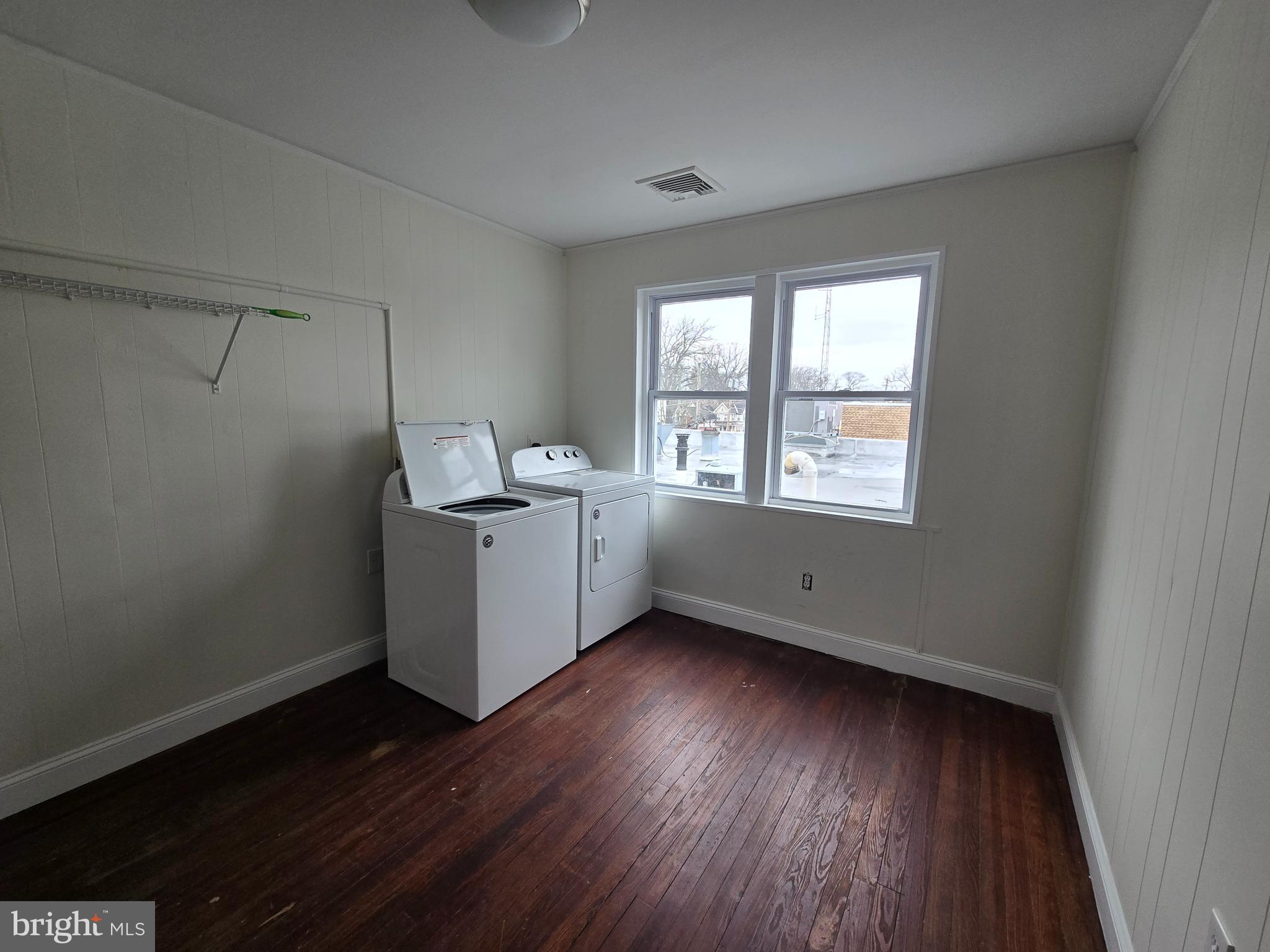 130 South Broadway Pitman, NJ 08071 - Photo 6 of 11 a view of an empty room with wooden floor and a window